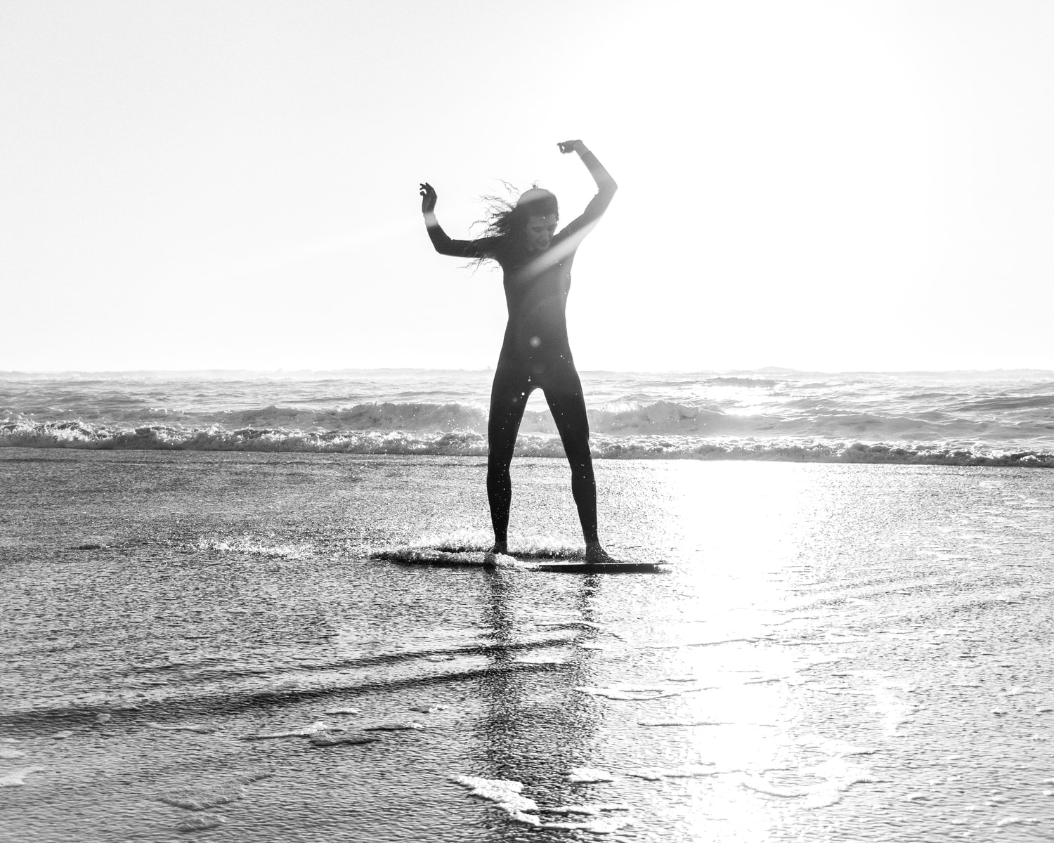michael_henry_rcqooe_Ehcl9 Young woman boogie boarding smiling about her future on the beach