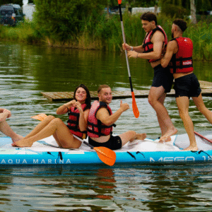 Recent college graduates sitting on a paddle board, symbolizing freedom and exploration after college.