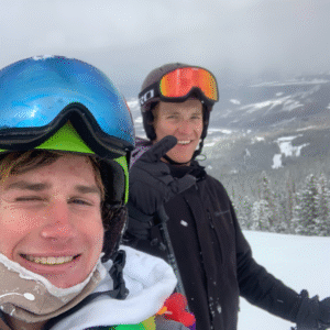 Student working a ski resort job during their gap year with snow-covered mountains in the background