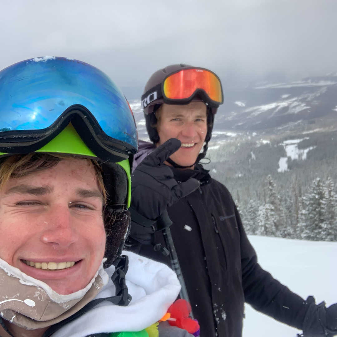 Student working a ski resort job during their gap year with snow-covered mountains in the background