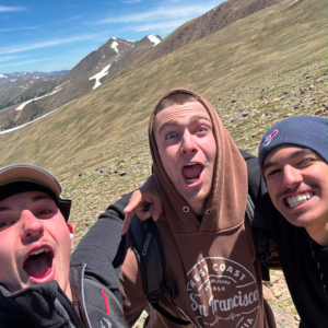 Group overlooking a vast mountain landscape at sunrise, representing the reflective and exploratory nature of a gap year with AdventureEXP.
