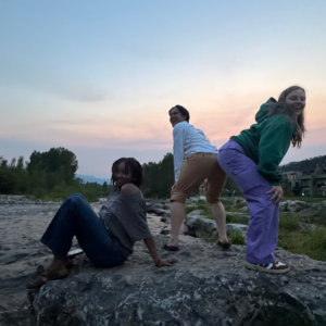 Your Future Isn't Hiding in a Classroom. It's Waiting in the World. A diverse group of young adults hiking together after work in a mountain town, building friendships, confidence, and real-world experience.