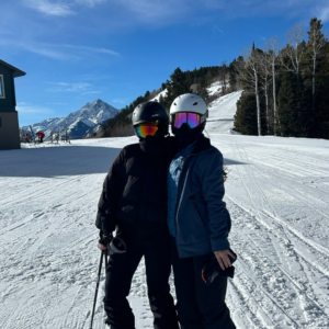 A group of young adults skiing together after work, building friendships and confidence through travel, adventure, and shared experiences.